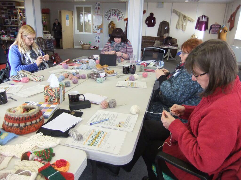 Knitters practicing colourwork at a class